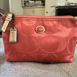 Like New, Coach vintage signature cosmetic pouch in a gorgeous melon/pinkish.